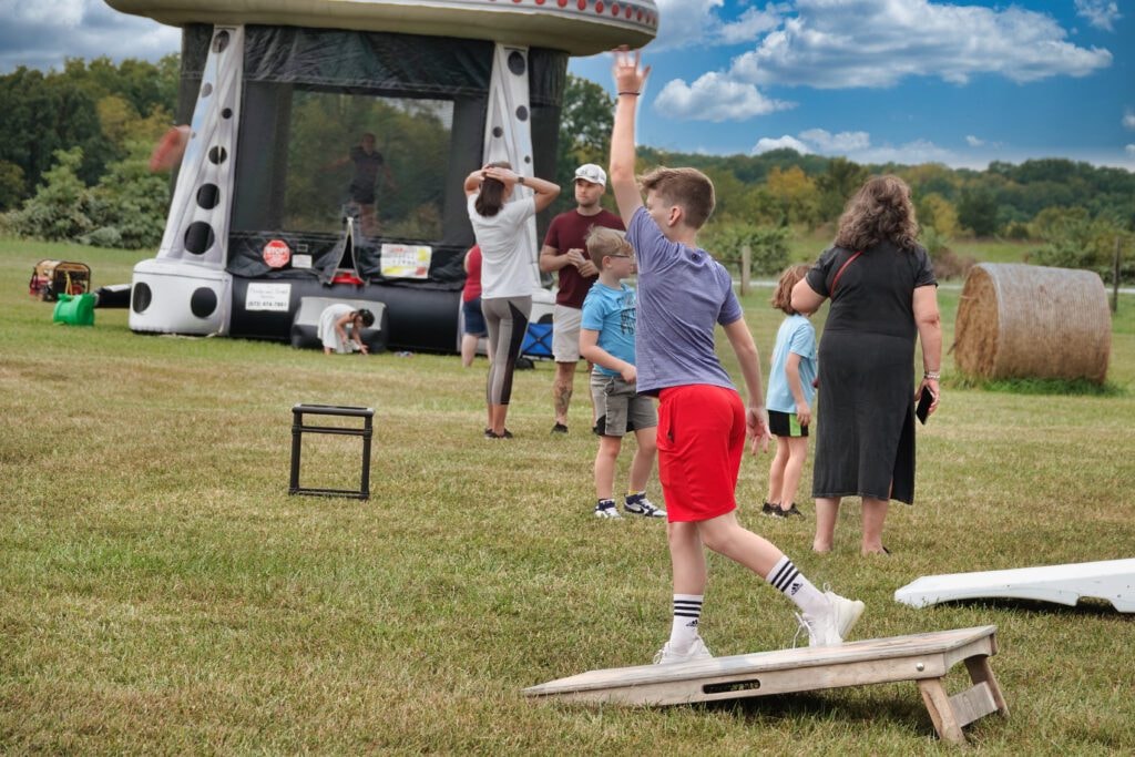 Bounce house and cornhole at Farm Day