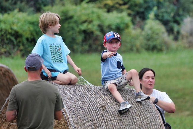 Kids on hay bale at Farm Day