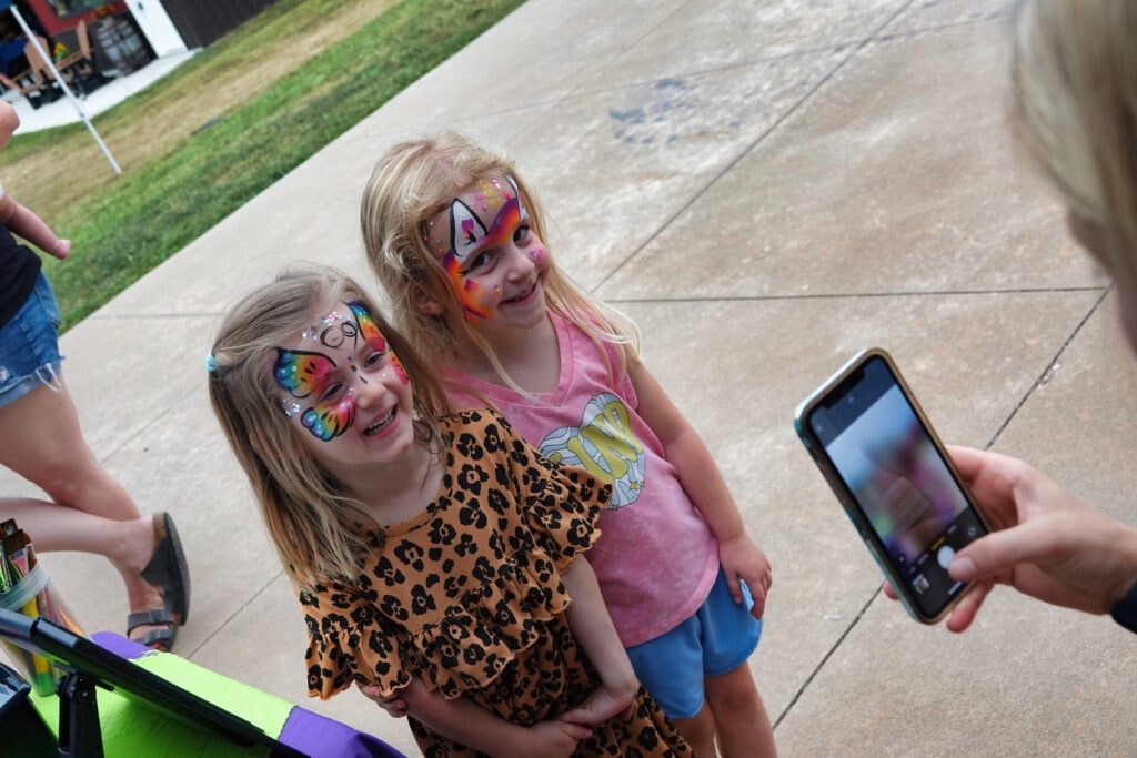 Two girls with face paint at Farm Day